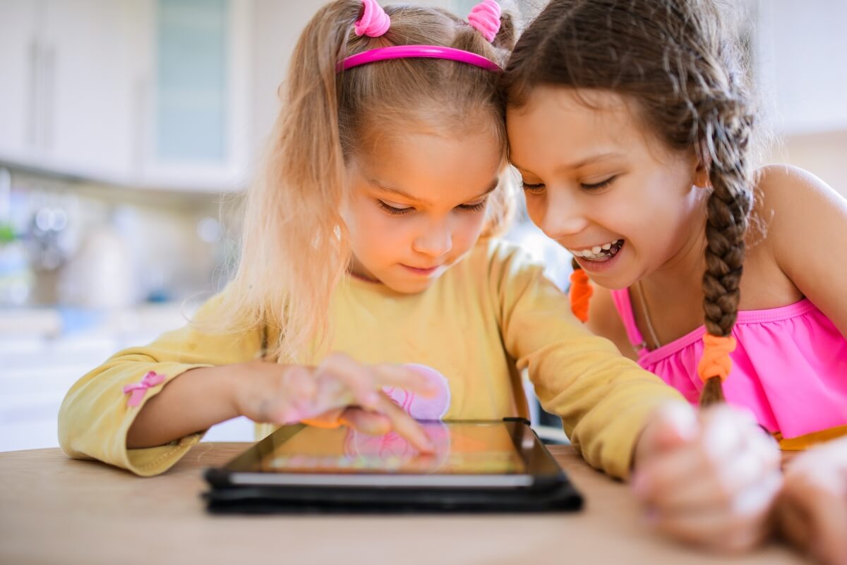 girls learning with tablet
