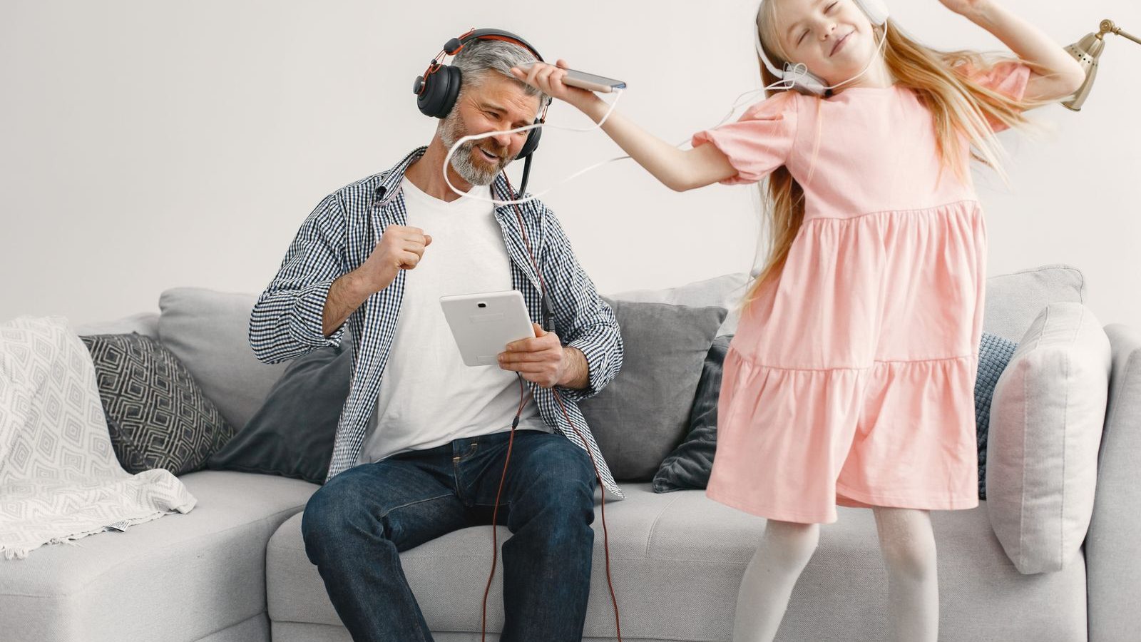 Parent and child dancing and laughing together at home