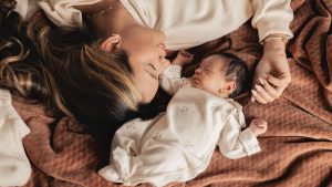 Parent and baby resting calmly together at bedtime