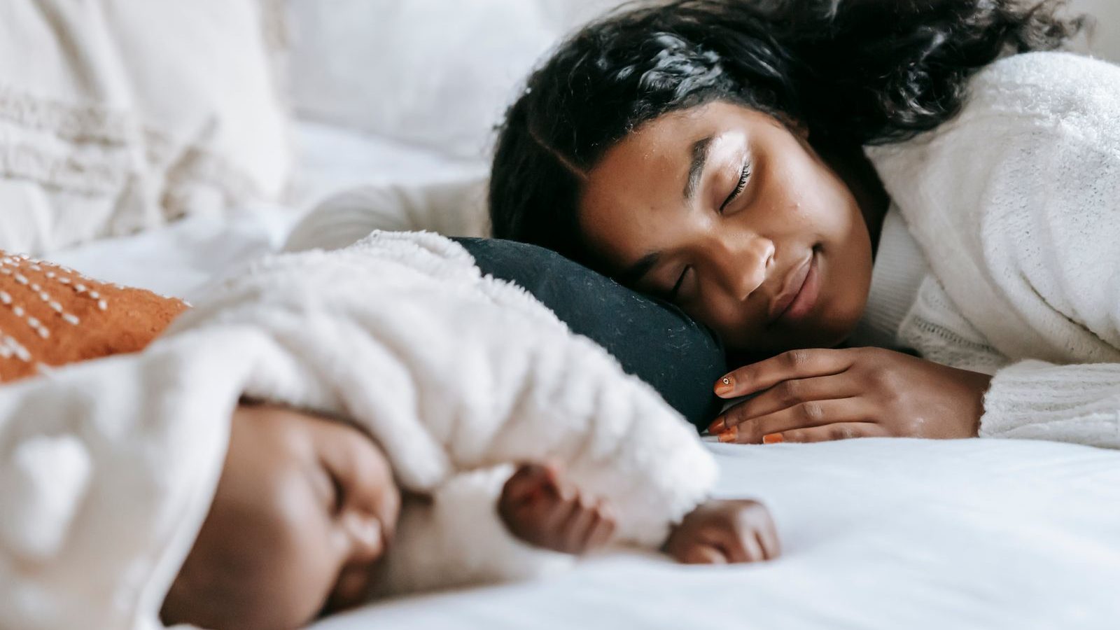 Parent and baby sleeping peacefully together