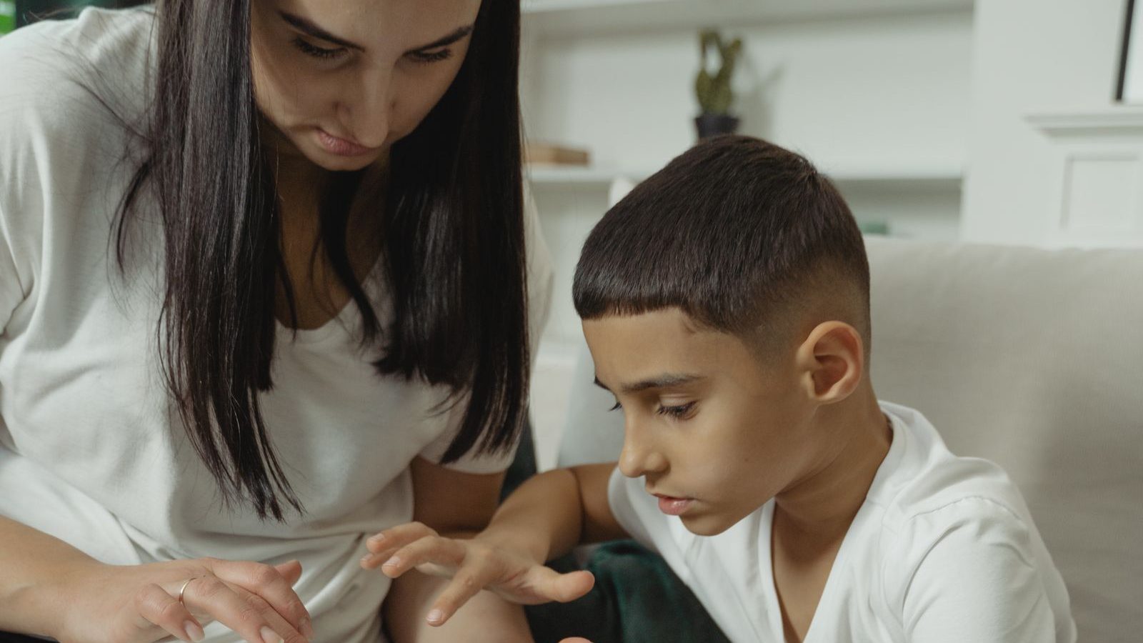 Parent and child looking at a tablet together at home