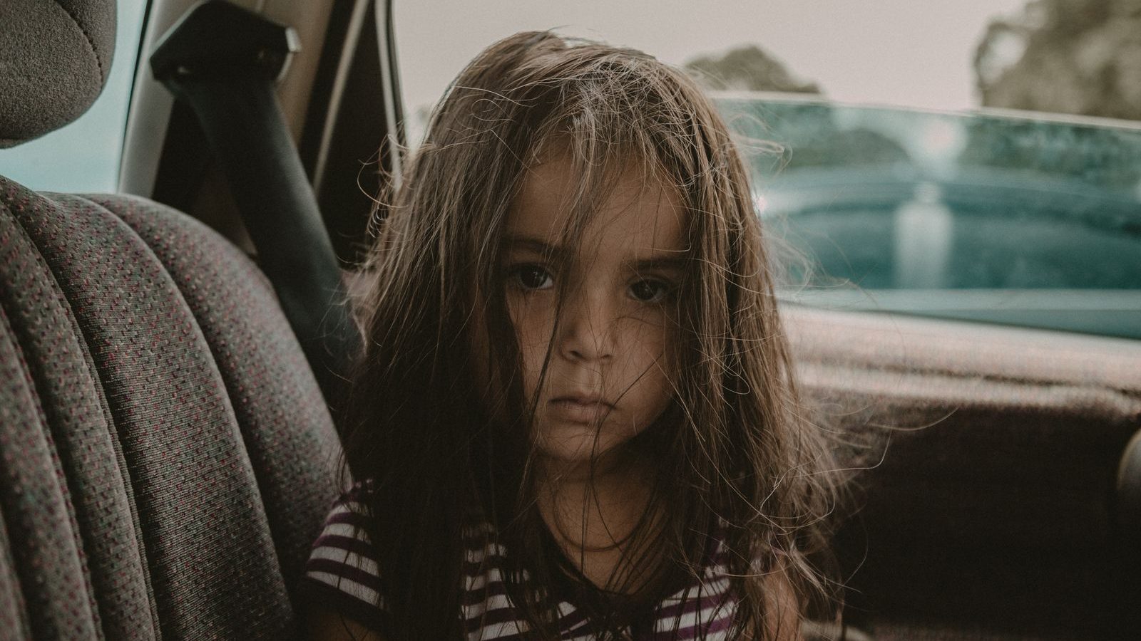 Young child sitting in a car seat during a car trip