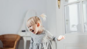 Happy toddler laughing while entertained