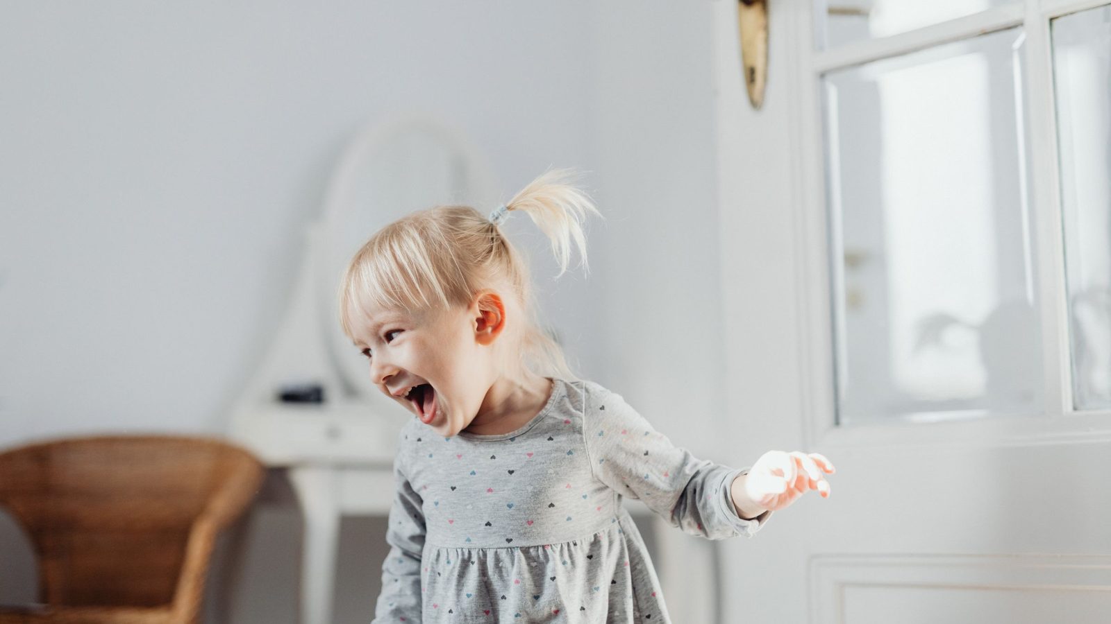 Happy toddler laughing while entertained