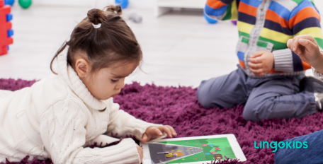 Little girl playing Lingokids in an iPad