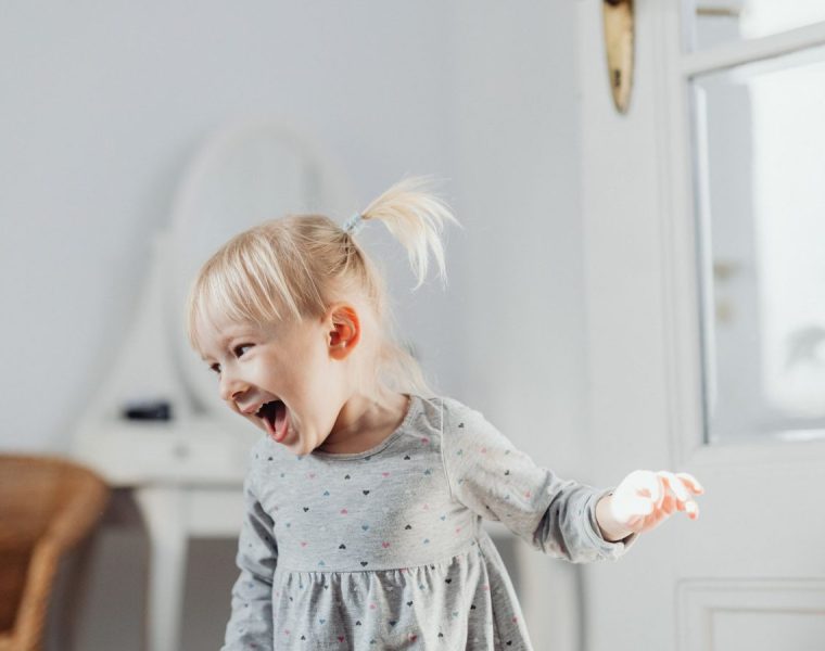 Happy toddler laughing while entertained
